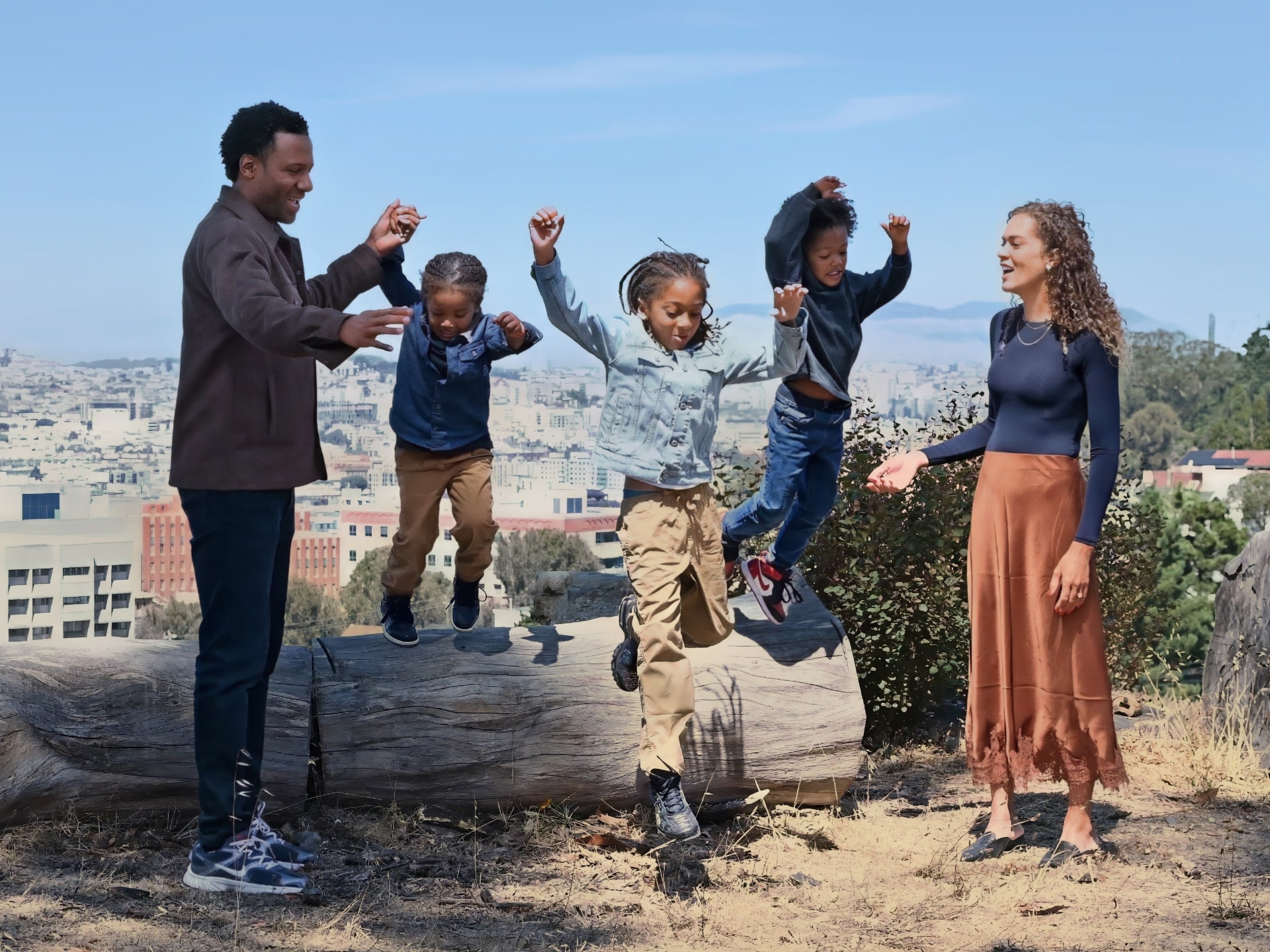 Theo Ellington and his family playing outdoors on a hillside overlooking San Francisco
